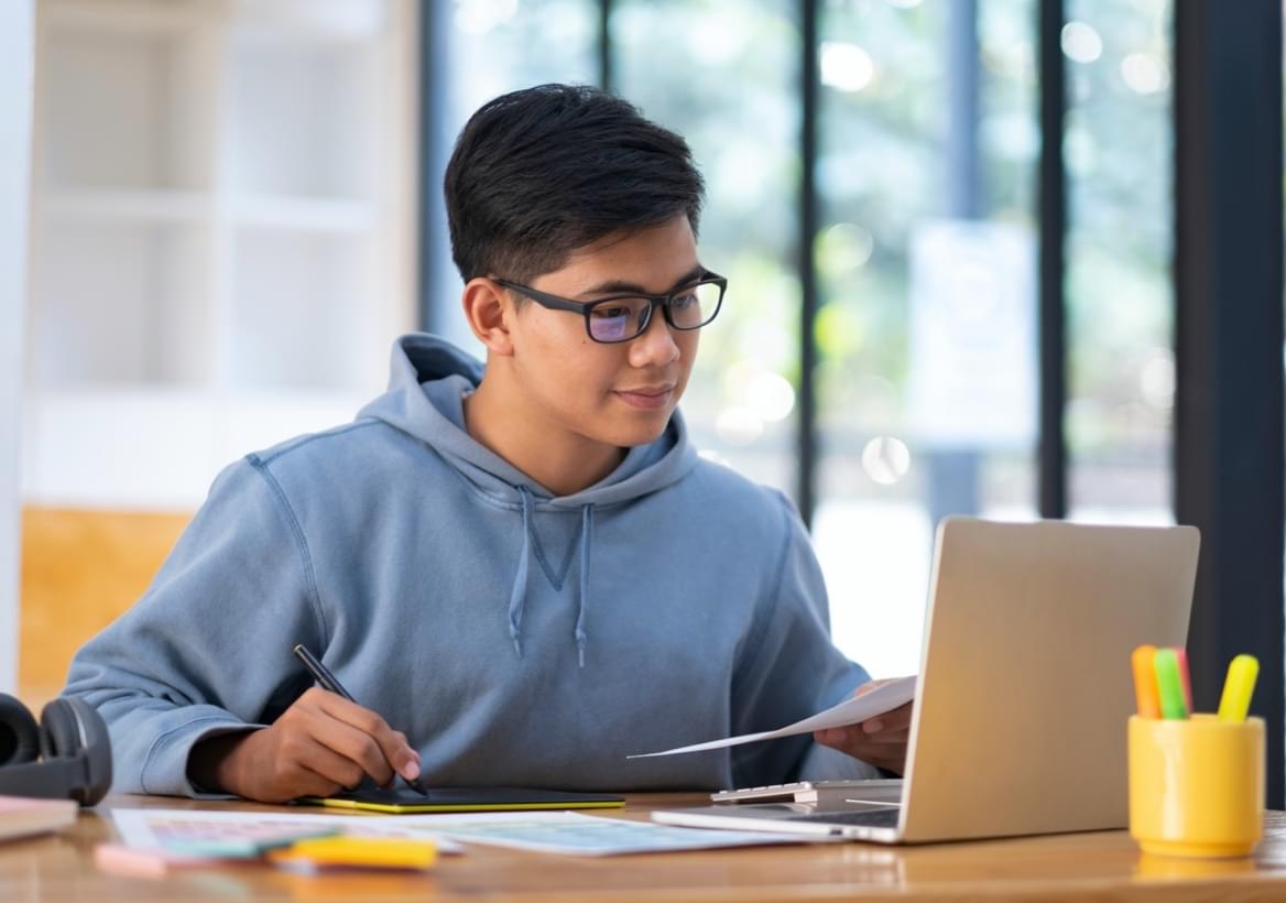 grade 9 student studying in front of computer